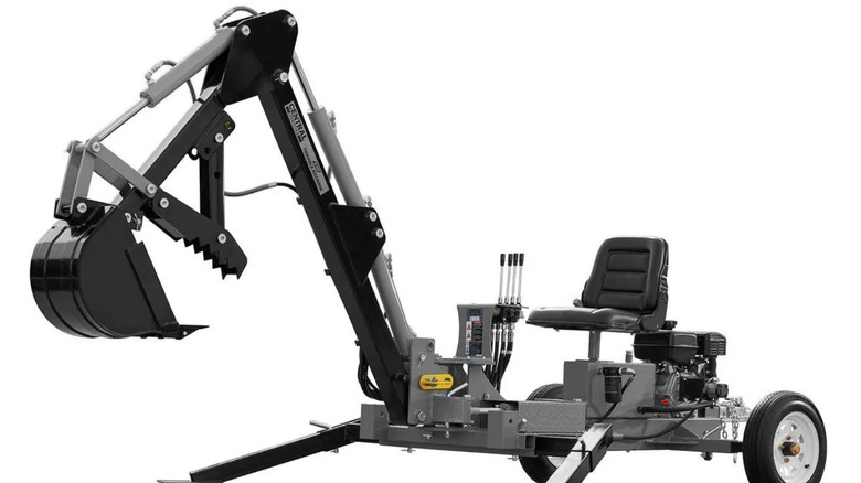 Black towable backhoe against white background