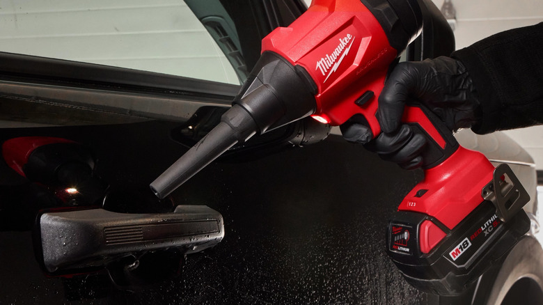 Milwaukee precision blower used to remove dust from car door handle