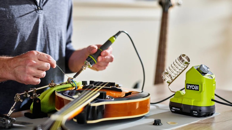 Ryobi 18V One+ 120W Soldering Iron being used to fix a stringed instrument
