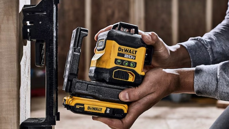 Person setting up 20V 3x360 Line Laser