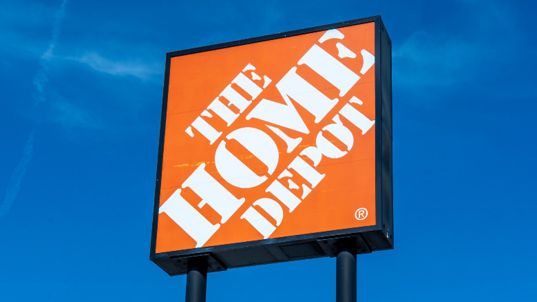 Home Depot sign on a clear blue sky.