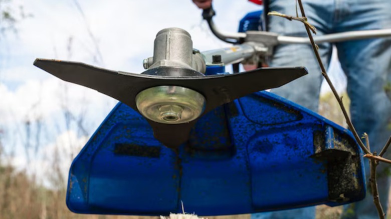 a closeup image of the wild badger power gas trimmer with brush cutter head