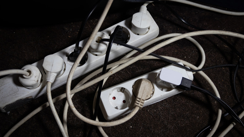 A power strips plugged into another power strip along with other cables.