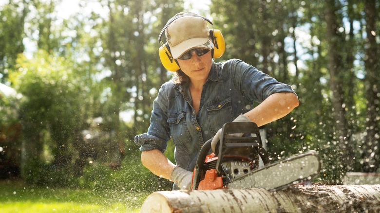 person using chainsaw