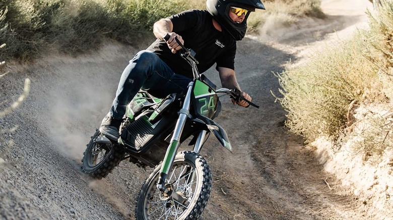 Rider driving a Drift Hero 212 cc Gas Mini Bike down a dirt road