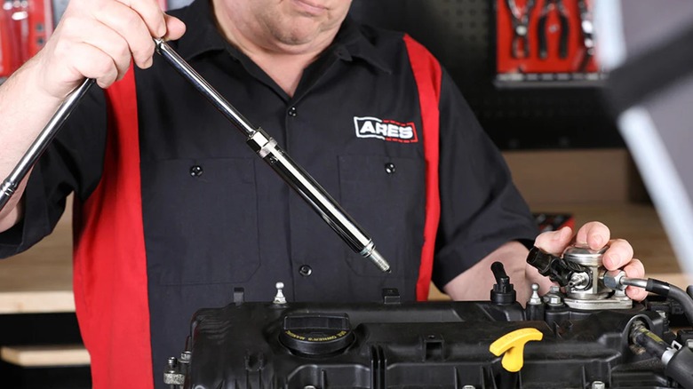 Person using gear from the Ares 10-piece Extra Deep and Standard-Length Magnetic Spark Plug Socket Set