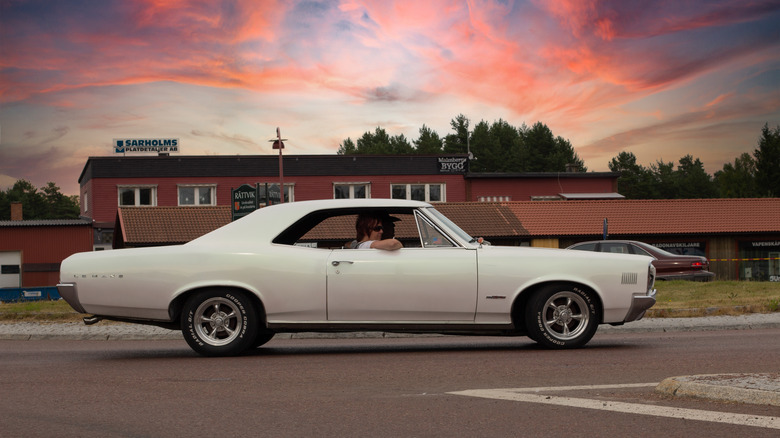 Man driving Pontiac LeMans