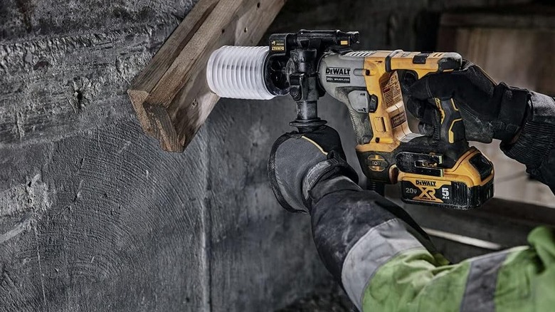 Person using DeWalt Hammer Drill on concrete