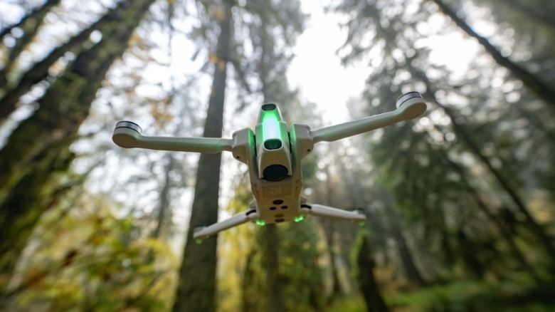 Antigravity A1 drone hovers midair in forest