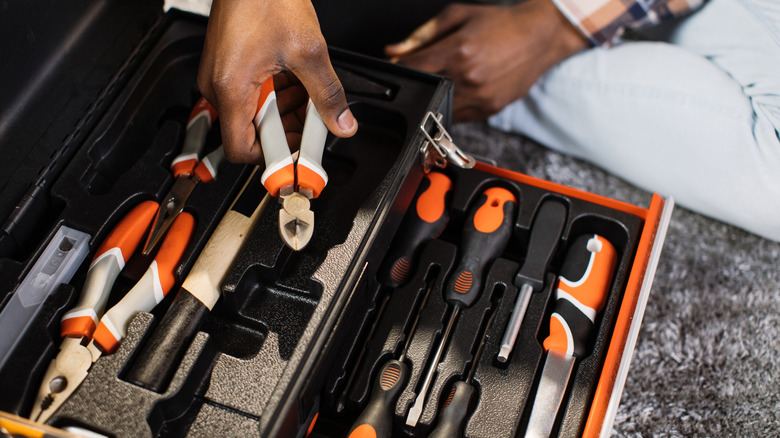 Person using fold-out toolbox