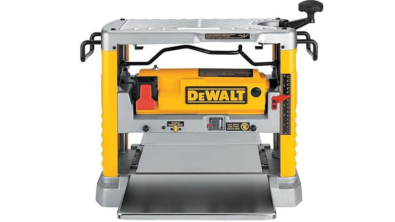 Yellow and black DeWalt Benchtop Planer with a white backgorund