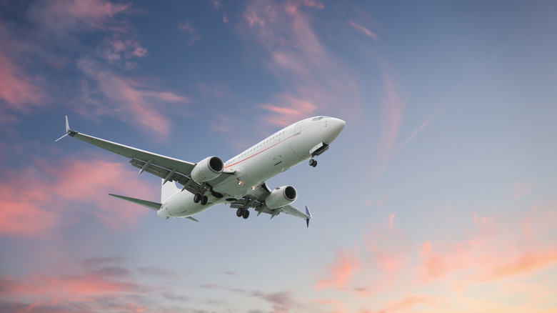 Aircraft taking off at sunset
