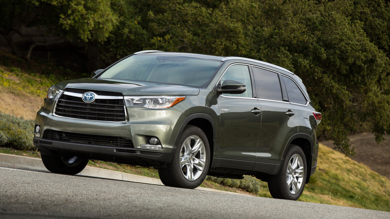 Light green Toyota Highlander parked on an elevated road