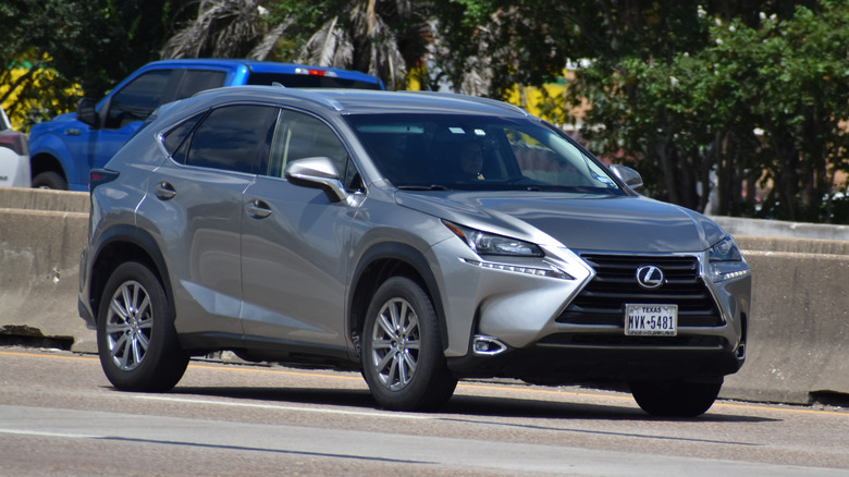 Silver Lexus NX cruising down the highway