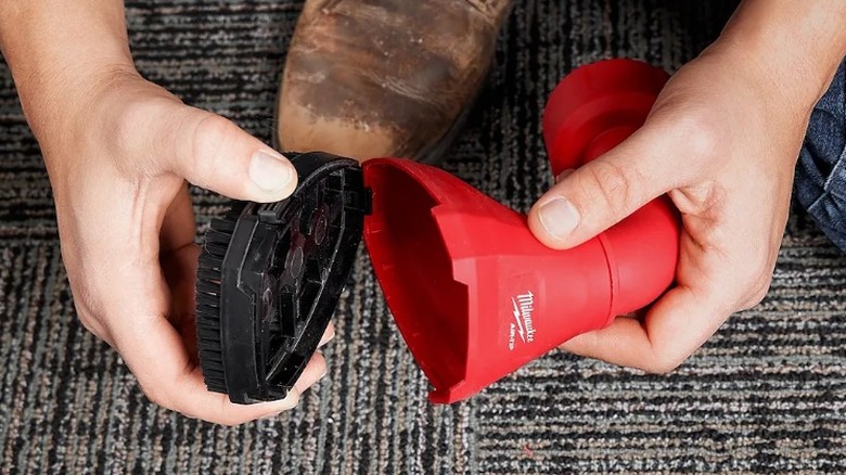 Person changing the brush on the Milwaukee Air-Tip Swiveling Palm Brush