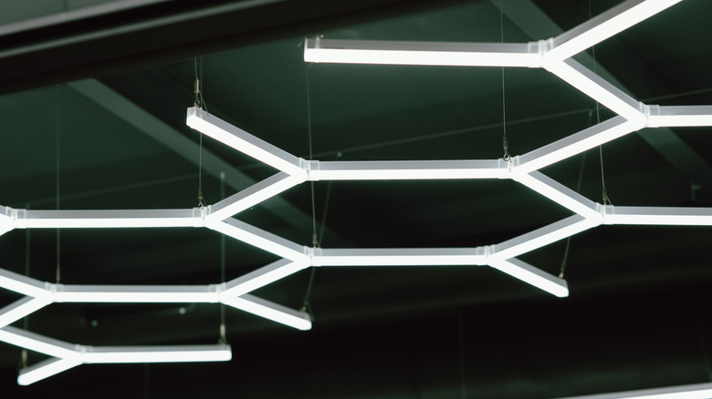 Bright hexagon-shaped LED lights suspended from a ceiling.