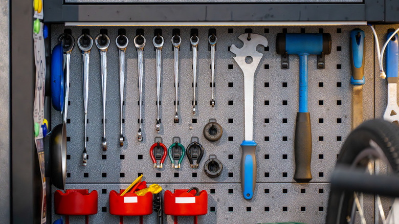 Several hand tools mounted on a pegboard