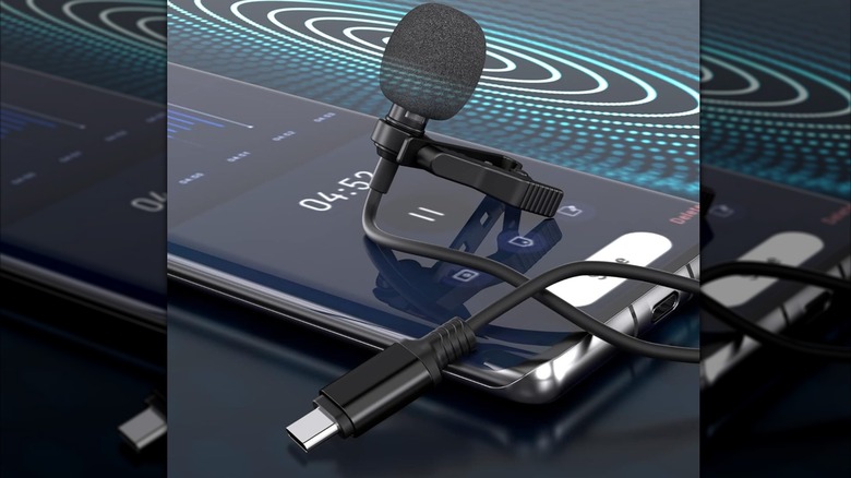 A Ttstar lavalier USB-C microphone resting on a phone