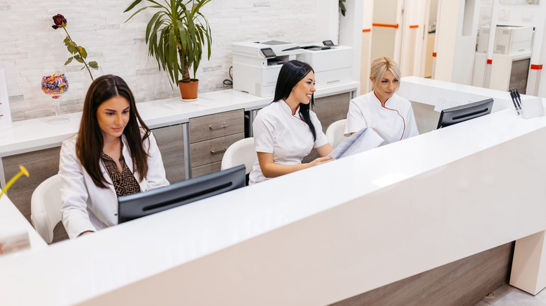 reception staff working at hospital