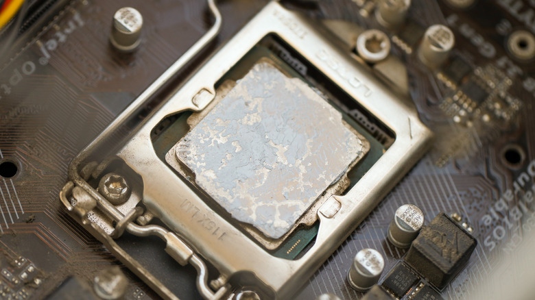 Old thermal paste on a CPU chip inside a motherboard.