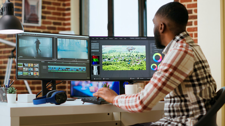 Man using two monitors for editing software