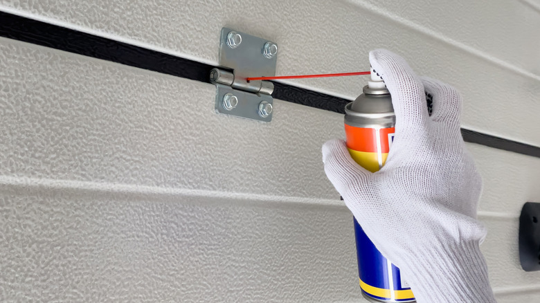 WD-40 being used on a hinge