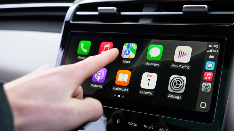 Close up of a hand interacting with CarPlay app screen