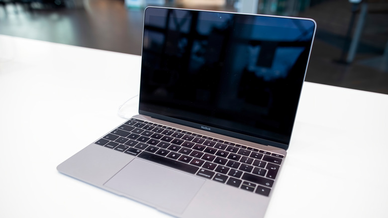 An older MacBook model on white table