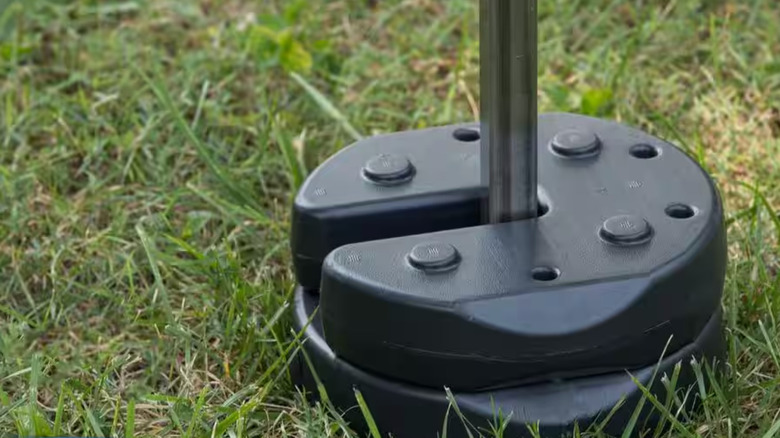 Weighted plates holding down a pole