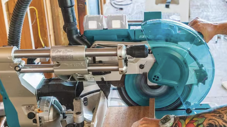 Miter saw cutting a piece of wood