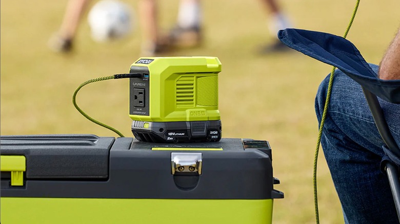 18V One+ 150W Power Source/Charger powering a phone at a soccer match