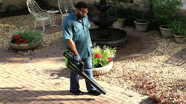 Greenworks electric leaf blower being used on patio