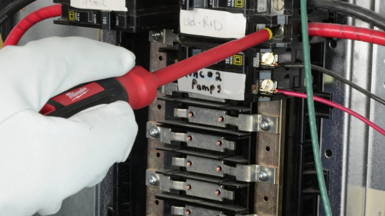 Milwaukee insulated screwdriver working on electric panel