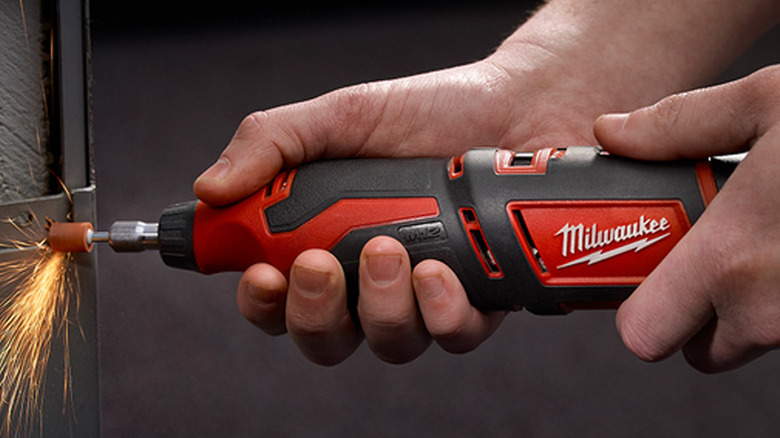 person using milwaukee rotary tool