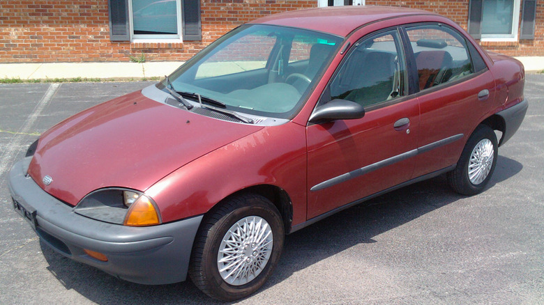 Red Geo Metro sedan in parking lot