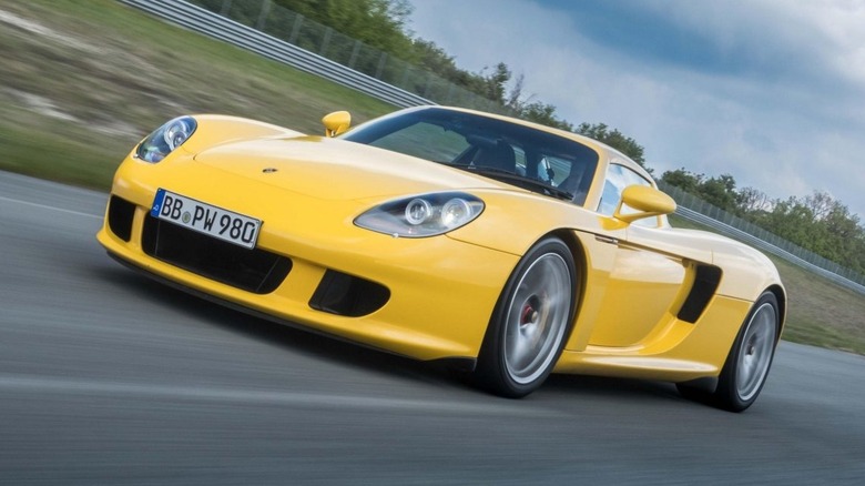 Yellow Porsche Carrera GT on a race track
