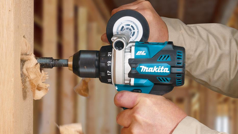 person using makita power drill