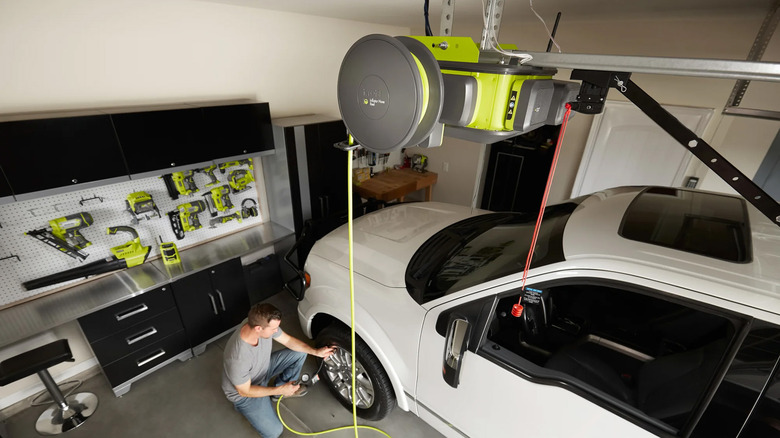 A man inflating a tire with a Ryobi Garage Air Inflator