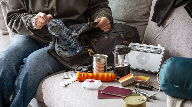 Person assembling an emergency kit