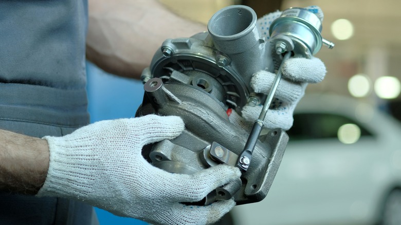 turbocharger in mechanic's hands