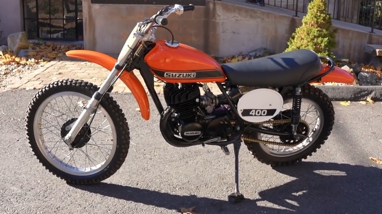An orange 1971 Suzuki TM400 in the sun