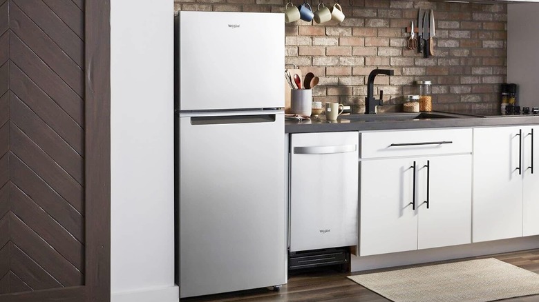 A Whirlpool Top Freezer refrigerator in a modern kitchen setup