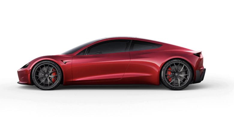 left side view of Red Tesla roadster on white background