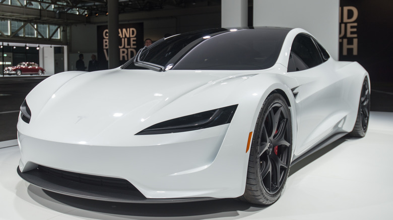 White Tesla Roadster on display at indoor car show