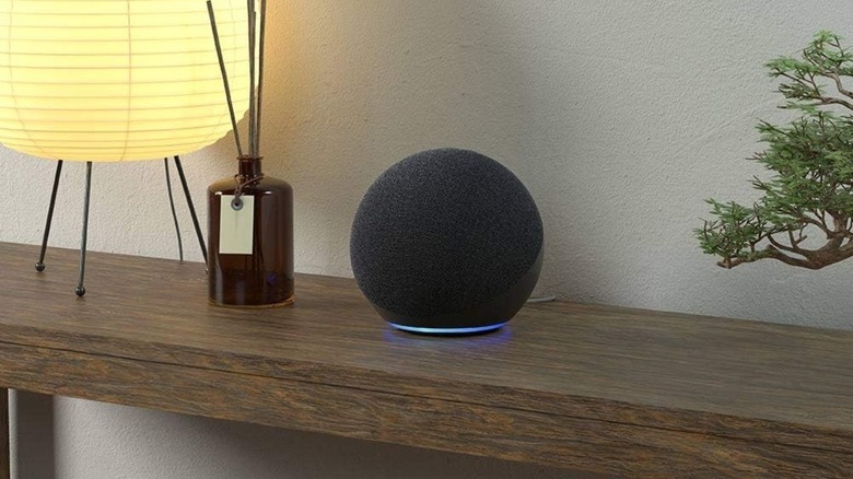 An Amazon Echo Dot placed on a wooden table