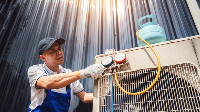 A person maintaining an HVAC system