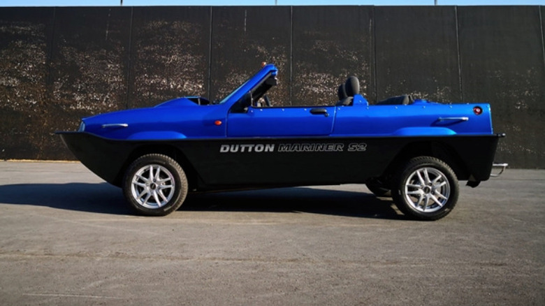 Dutton Mariner S2 amphibious car in blue, parked on land, showcasing its dual-purpose design for road and water use.