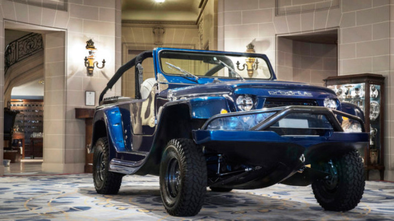 Prodrive WaterCar Panther amphibious SUV on display indoors, showcasing its rugged off-road design and aquatic capabilities.