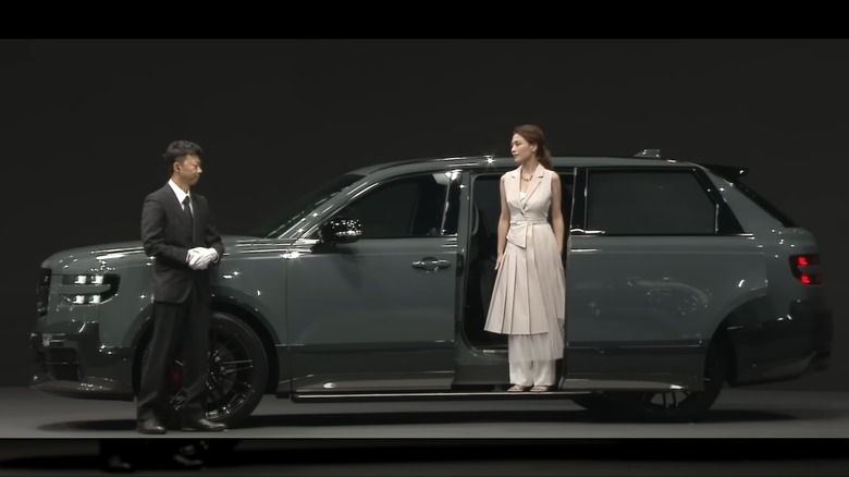 A lady stepping out of the Toyota Century SUV