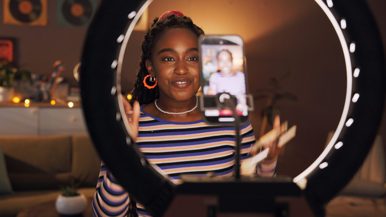 Persons looking into smartphone on a stand